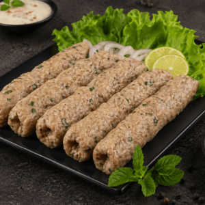 Unfried Shahi Malai Kabab raw creamy chicken seekh kebabs on black plate premium frozen food Pak N Pure www.paknpure.com